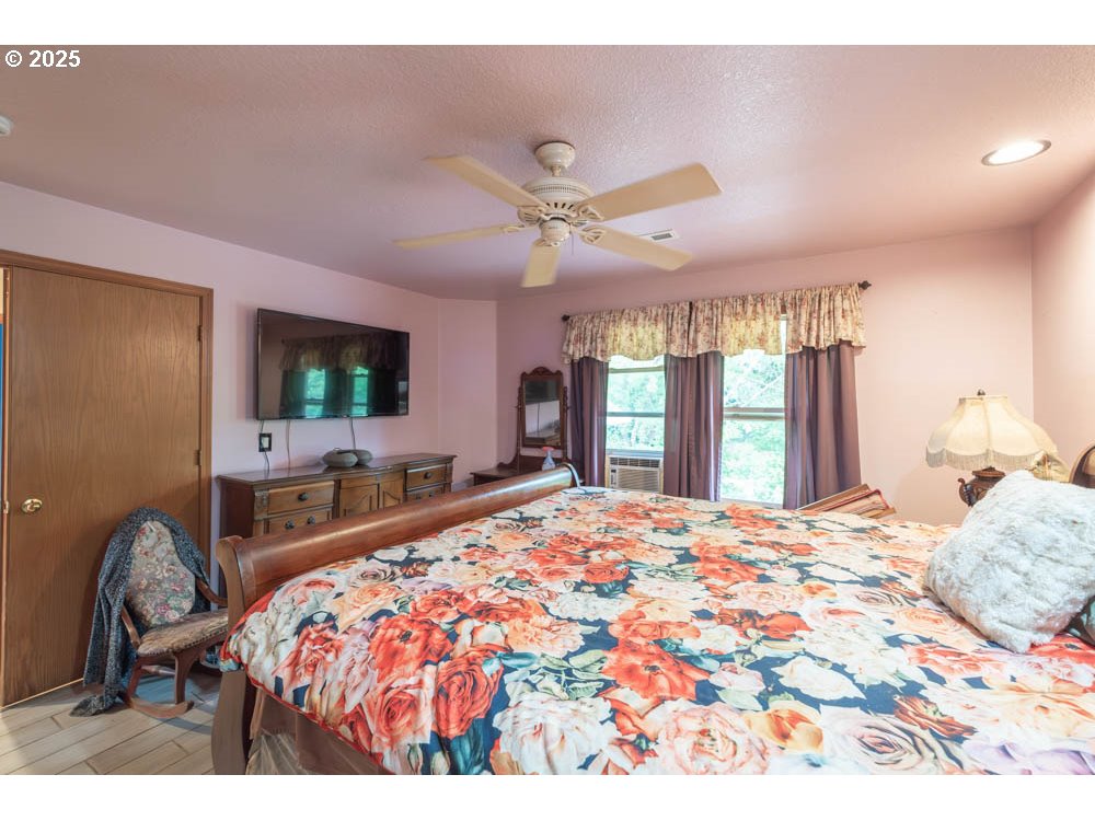 609 Van Buren Street Oregon City, OR 97045 - Photo 26 of 34 a bedroom with a bed window and a flat screen tv