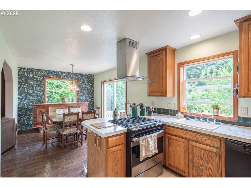 609 Van Buren Street Oregon City, OR 97045 - Photo 5 of 34 a kitchen with a stove a sink and a refrigerator