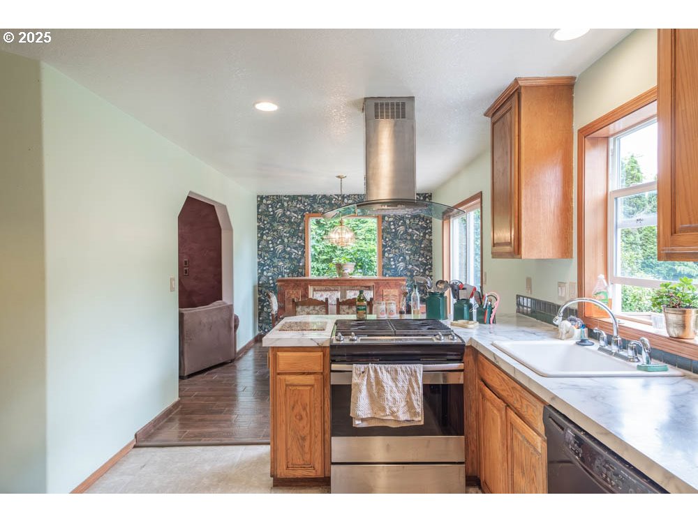 609 Van Buren Street Oregon City, OR 97045 - Photo 6 of 34 a kitchen with a sink stove and cabinets