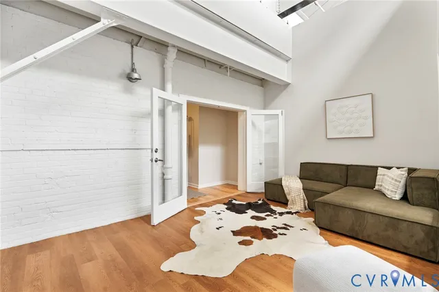 walk in closet with window and wooden floor