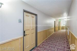 223 Hunter Road, Unit B303 Brian Head, UT 84719 - Photo 4 of 49 Hallway featuring a wainscoted wall and carpet flooring