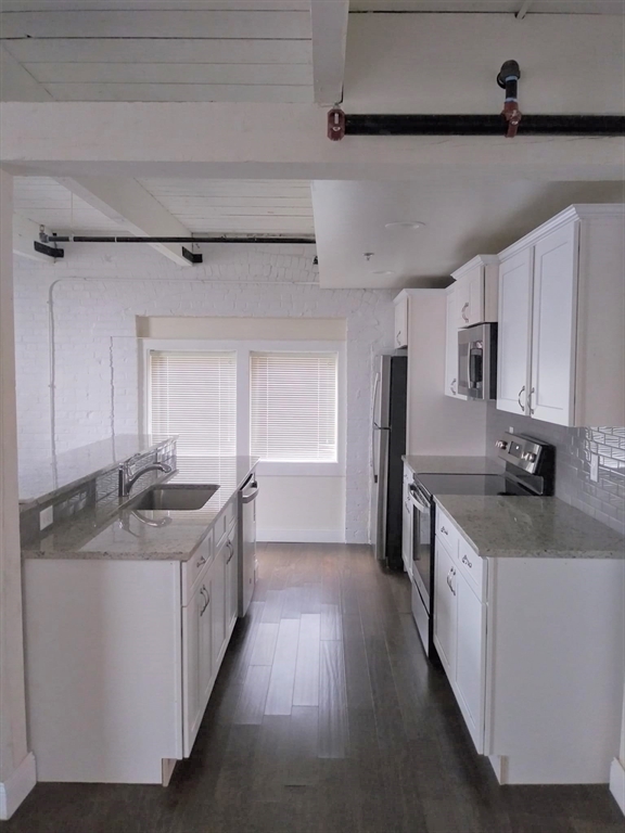 45 Summer Street, Unit 109 Leominster, MA 01453 - Photo 2 of 7 a kitchen with a sink stove and cabinets