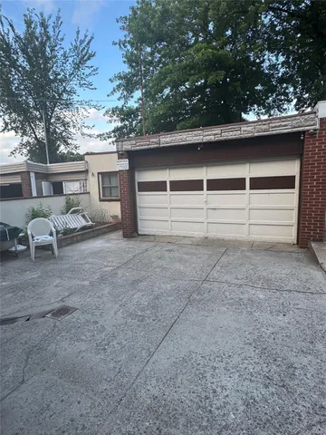 a view of a house with a yard and garage