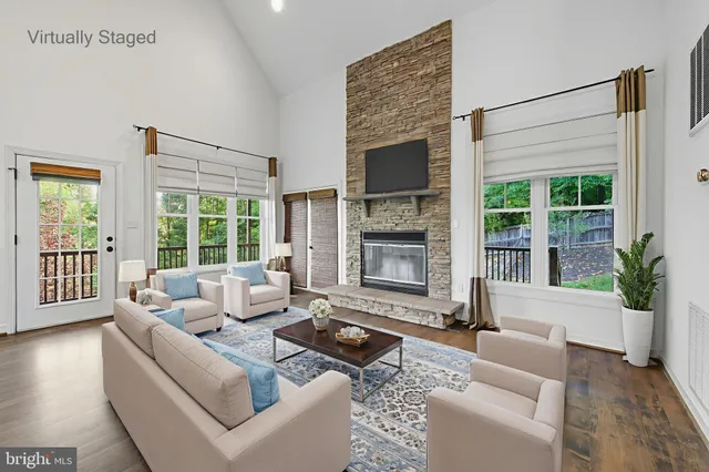 a kitchen with stainless steel appliances granite countertop a stove top oven a sink dishwasher a dining table and chairs with wooden floor