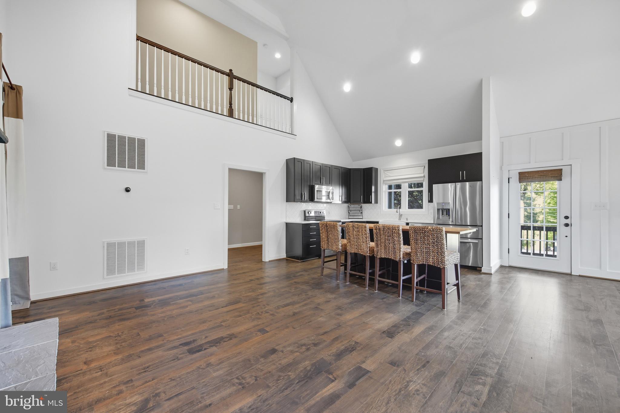 540 Mcdonalds Farm Road Linden, VA 22642 - Photo 17 of 60 a living room with stainless steel appliances kitchen island granite countertop wooden floor and a view of kitchen