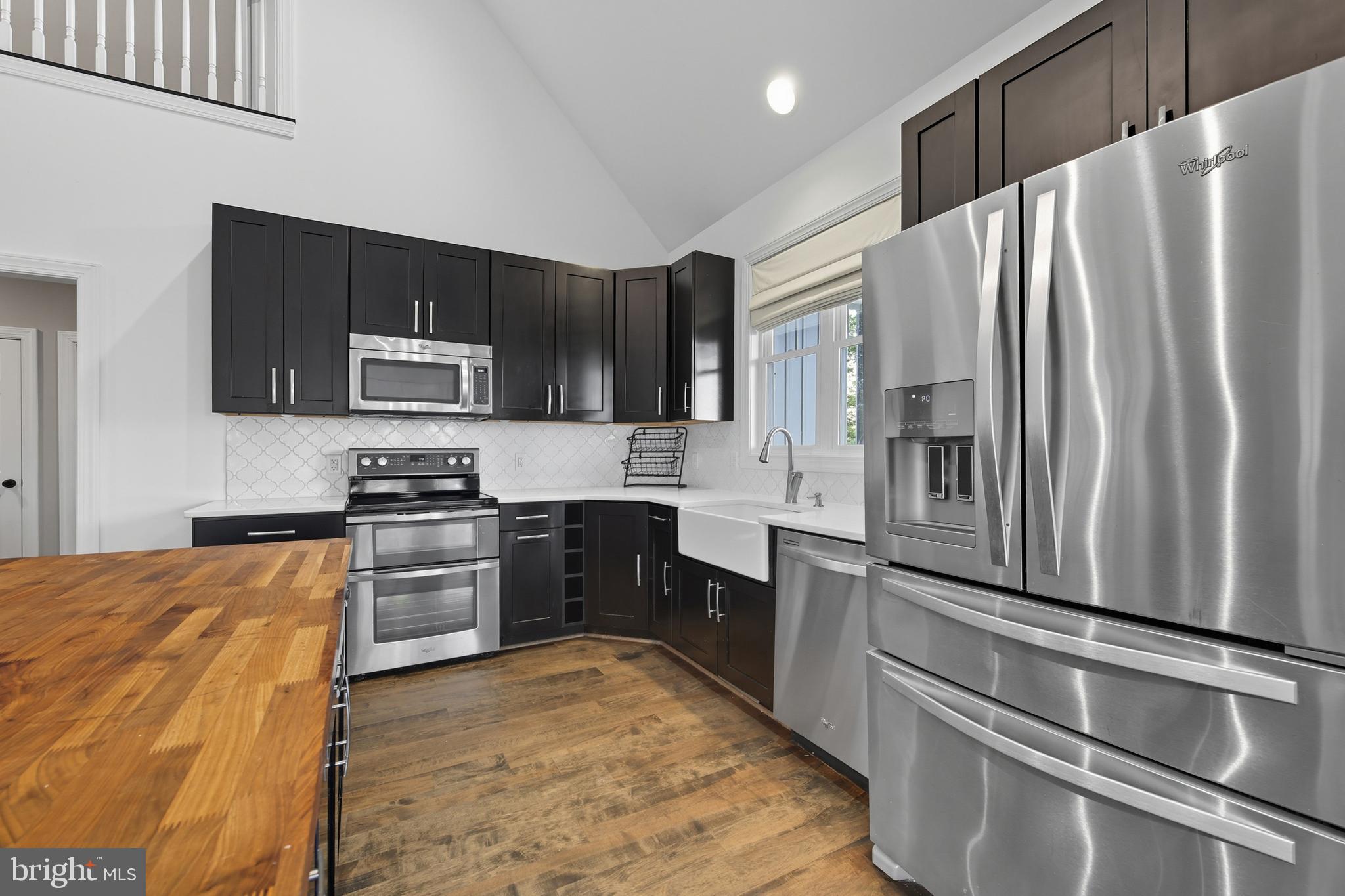 540 Mcdonalds Farm Road Linden, VA 22642 - Photo 18 of 60 a kitchen with granite countertop a refrigerator stove and microwave