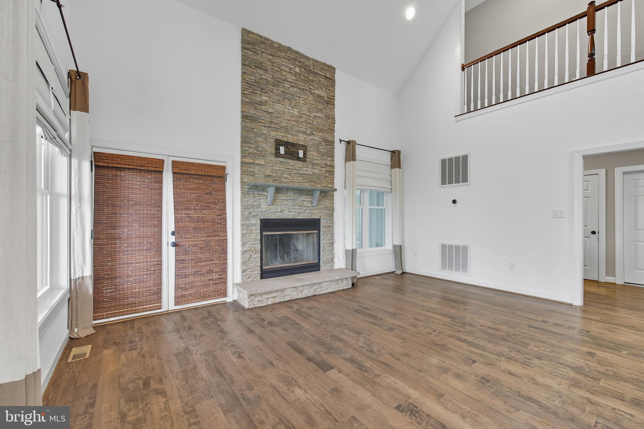540 Mcdonalds Farm Road Linden, VA 22642 - Photo 23 of 60 an empty room with wooden floor fireplace and windows