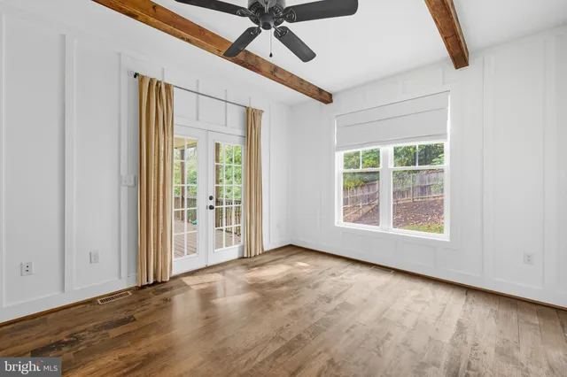 a bedroom with a bed a couch and a window