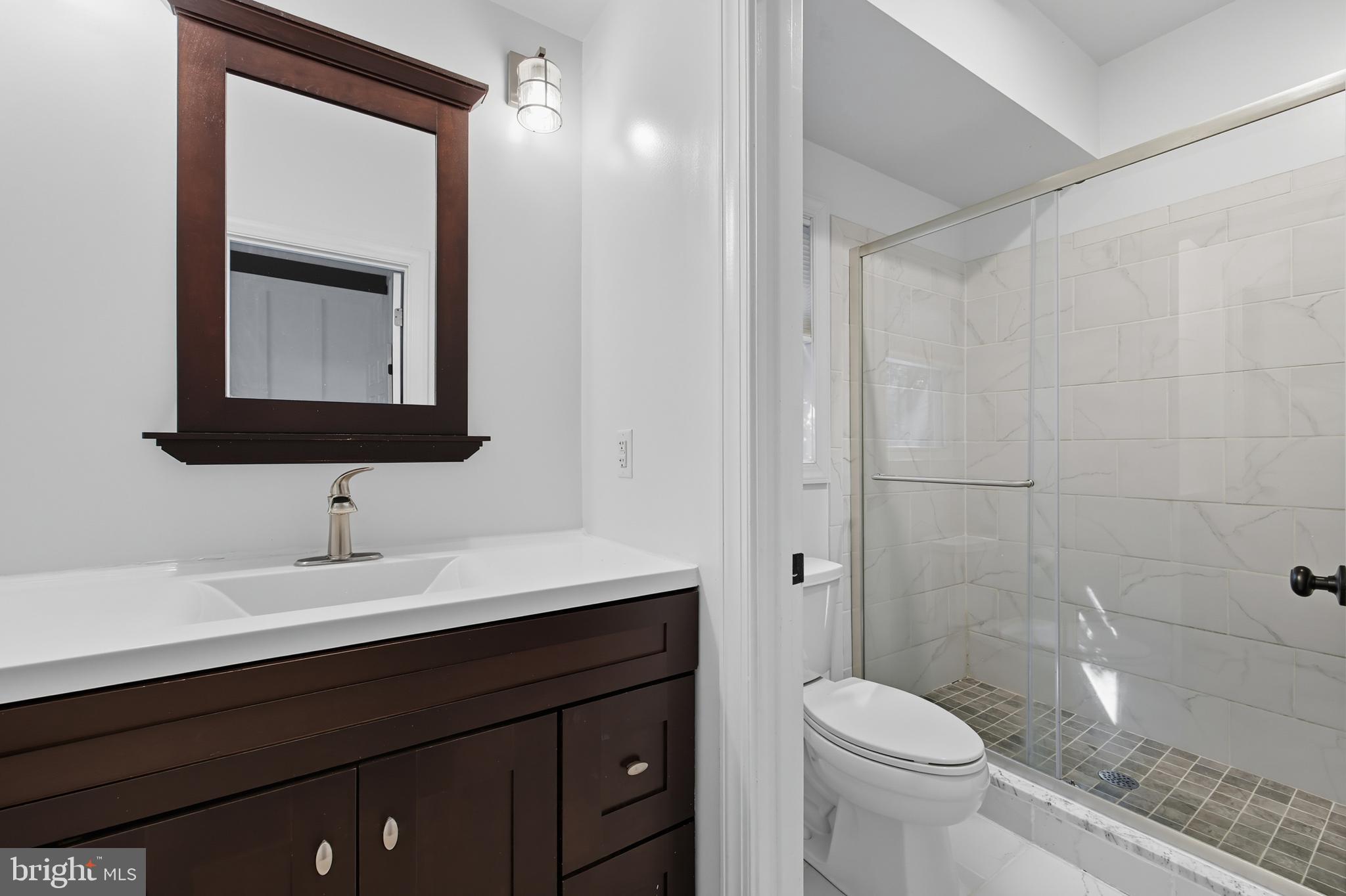 540 Mcdonalds Farm Road Linden, VA 22642 - Photo 29 of 60 a bathroom with a toilet sink and mirror