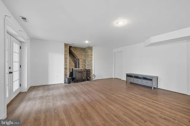 a view of storage and utility room with hardwood floor