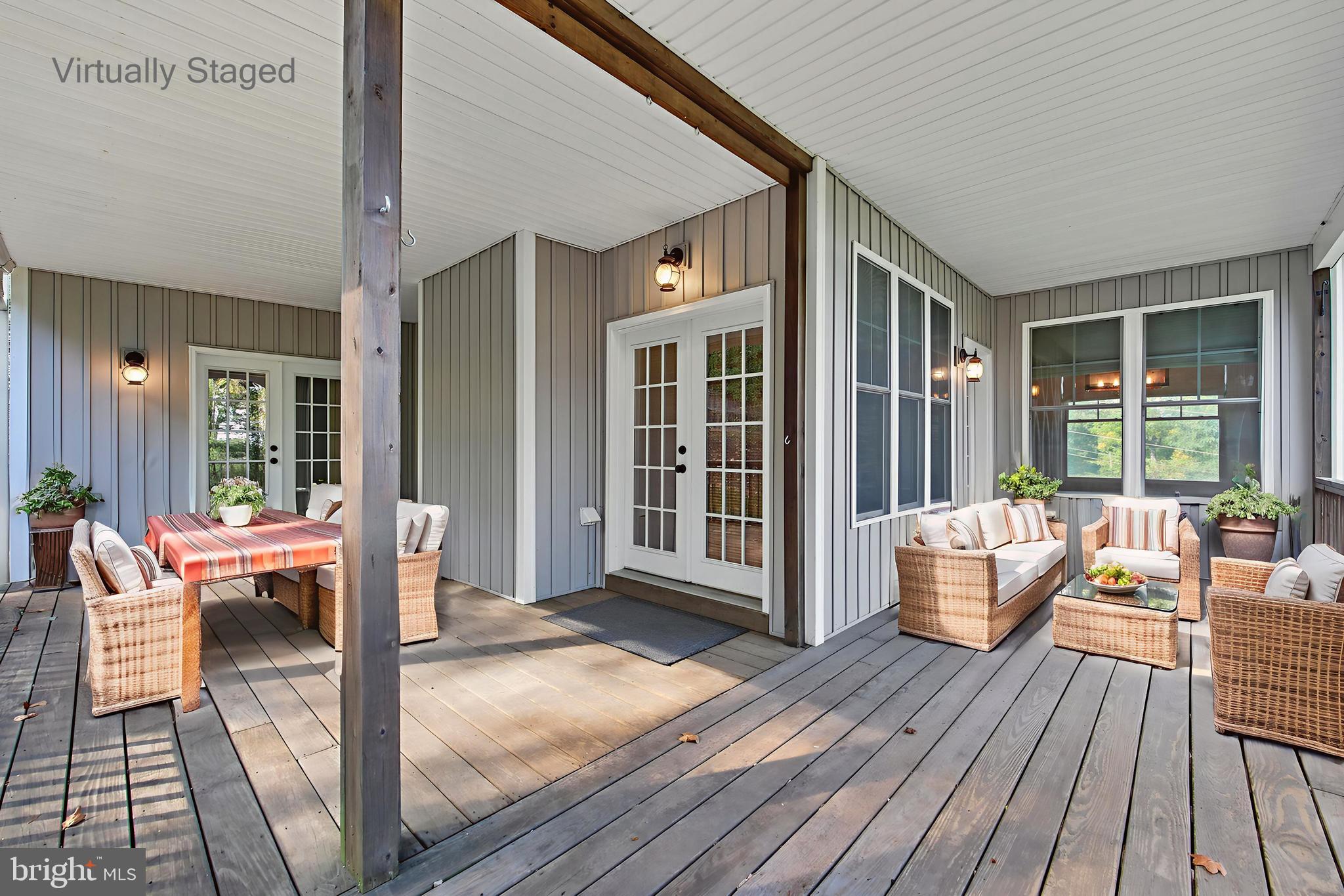 540 Mcdonalds Farm Road Linden, VA 22642 - Photo 6 of 60 a outdoor space with patio the couches and a dining table with wooden floor