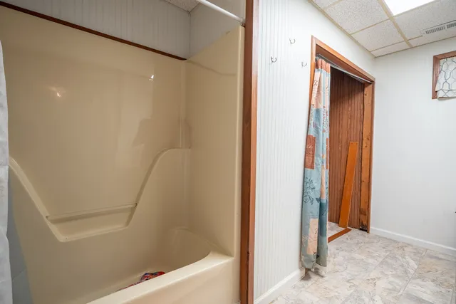 a view of a bathroom from a corridor