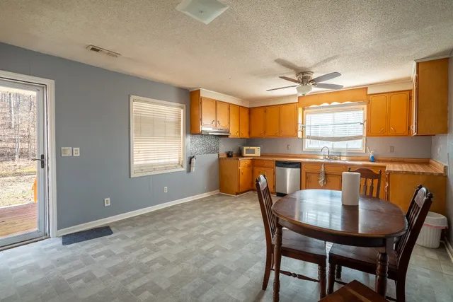 a view of a dining room with furniture and a window