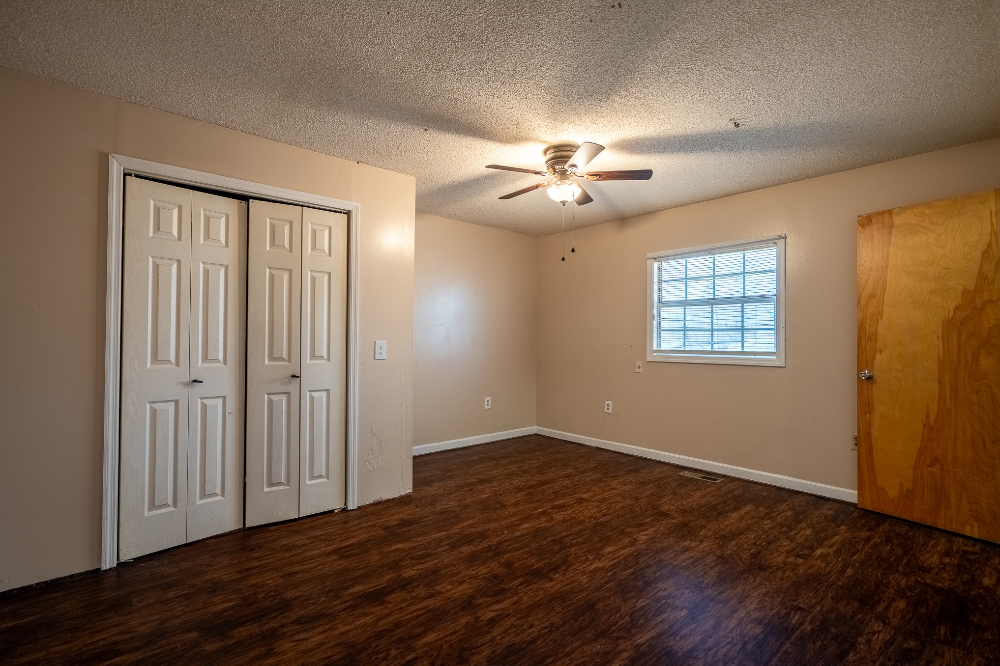 75 Buie Road Summertown, TN 38483 - Photo 9 of 27 a view of an empty room with a window and wooden floor