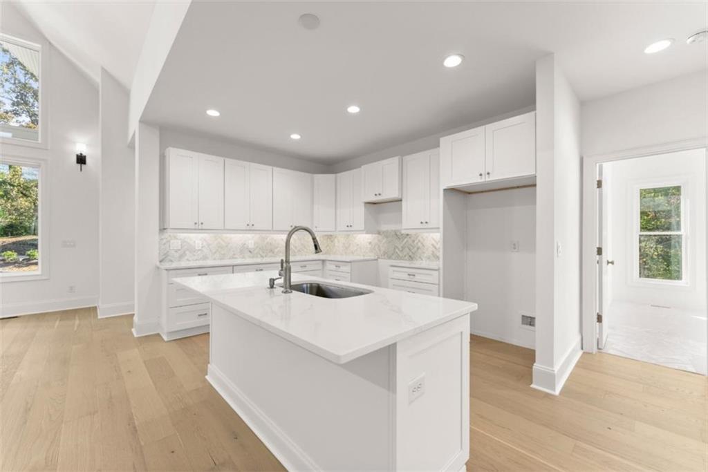 2123 Goat Neck Road Cleveland, GA 30528 - Photo 17 of 66 a kitchen with a sink white cabinets and stainless steel appliances