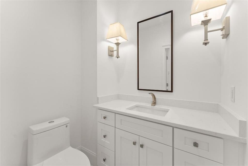 2123 Goat Neck Road Cleveland, GA 30528 - Photo 31 of 66 a bathroom with a toilet sink and mirror