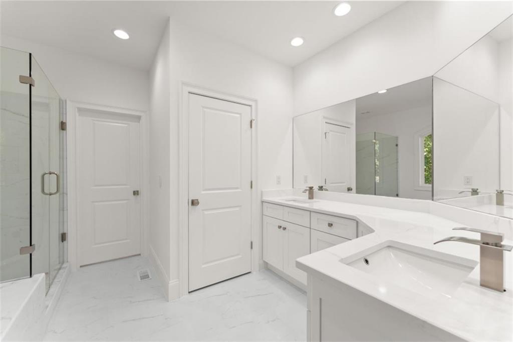 2123 Goat Neck Road Cleveland, GA 30528 - Photo 40 of 66 a spacious bathroom with a shower sink and mirror