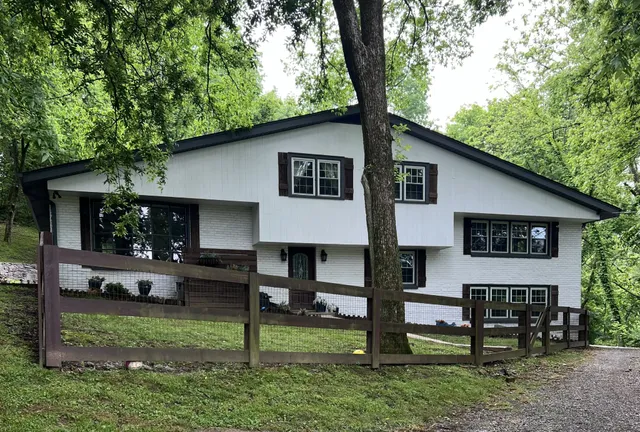 a house view with a sitting space and garden