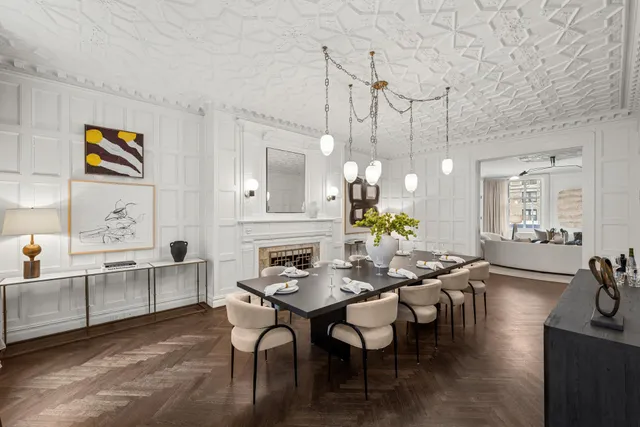 a view of a dining room with furniture a chandelier and wooden floor