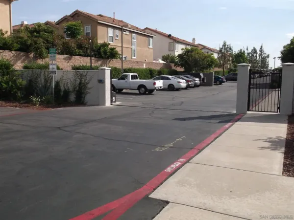 a view of a street with a car parked on the road