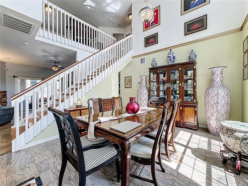 2048 Applegate Drive Ocoee, FL 34761 - Photo 17 of 61 a dining room with furniture and wooden floor