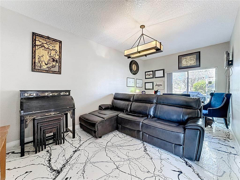 2048 Applegate Drive Ocoee, FL 34761 - Photo 34 of 61 a living room with furniture a rug and a piano