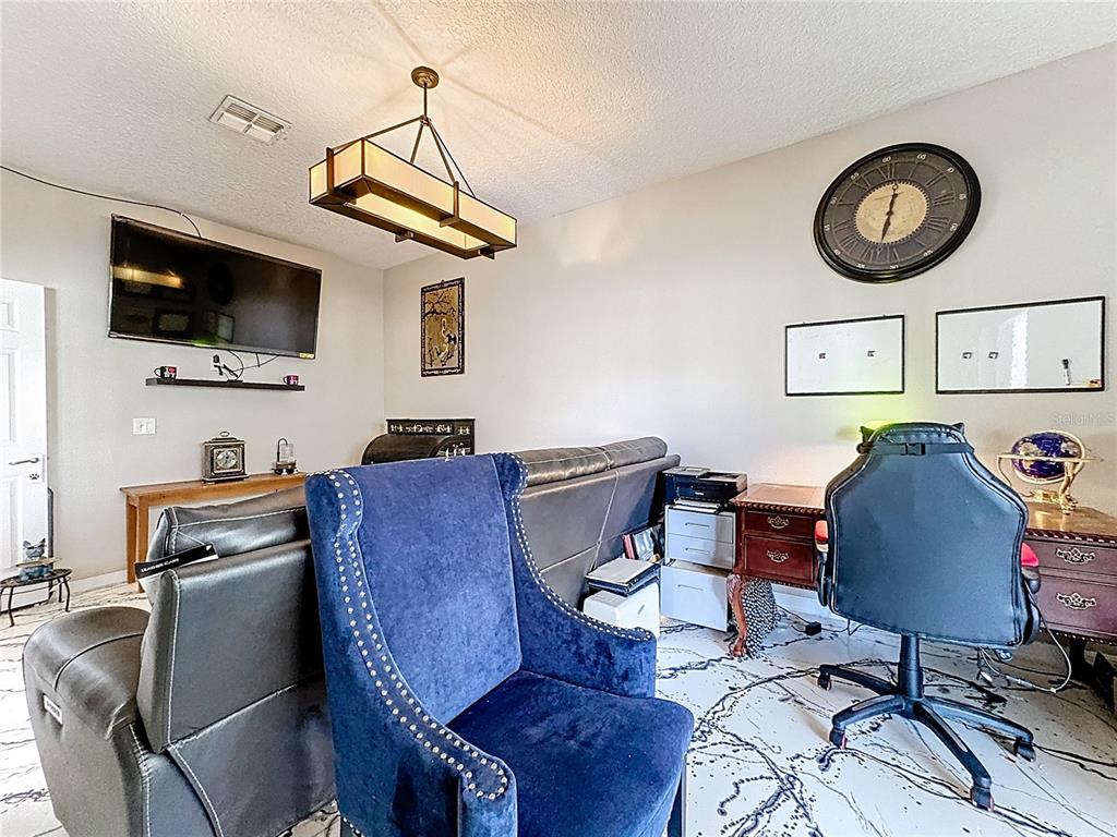 2048 Applegate Drive Ocoee, FL 34761 - Photo 35 of 61 a view of a workspace with furniture and a flat screen tv