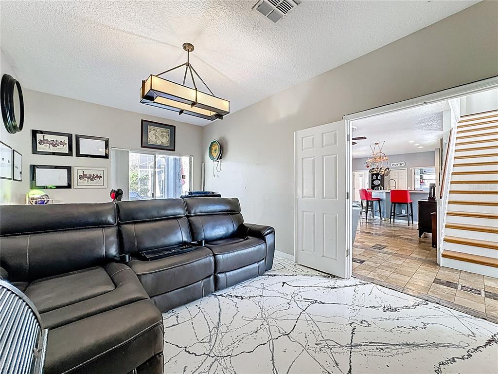 2048 Applegate Drive Ocoee, FL 34761 - Photo 36 of 61 a living room with furniture a rug and white walls