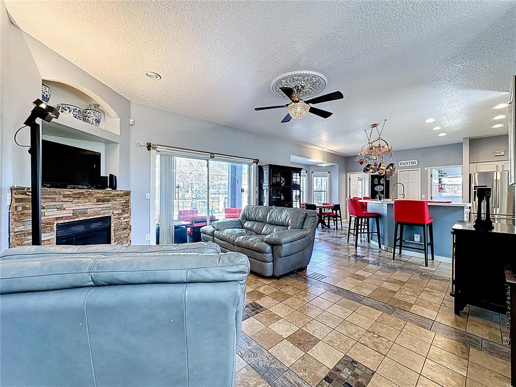 2048 Applegate Drive Ocoee, FL 34761 - Photo 37 of 61 a living room with furniture a fireplace and a flat screen tv