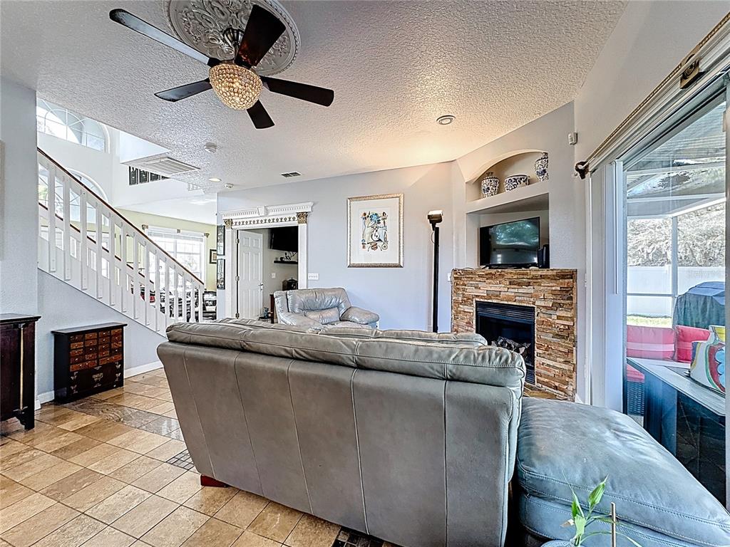 2048 Applegate Drive Ocoee, FL 34761 - Photo 39 of 61 a living room with furniture and a fireplace