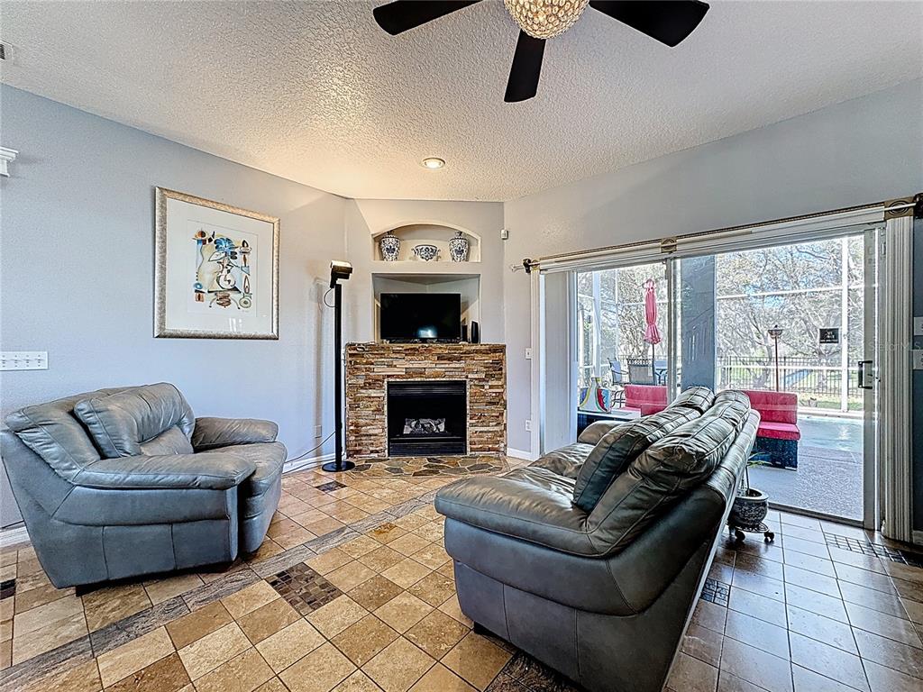 2048 Applegate Drive Ocoee, FL 34761 - Photo 40 of 61 a living room with furniture and a fireplace