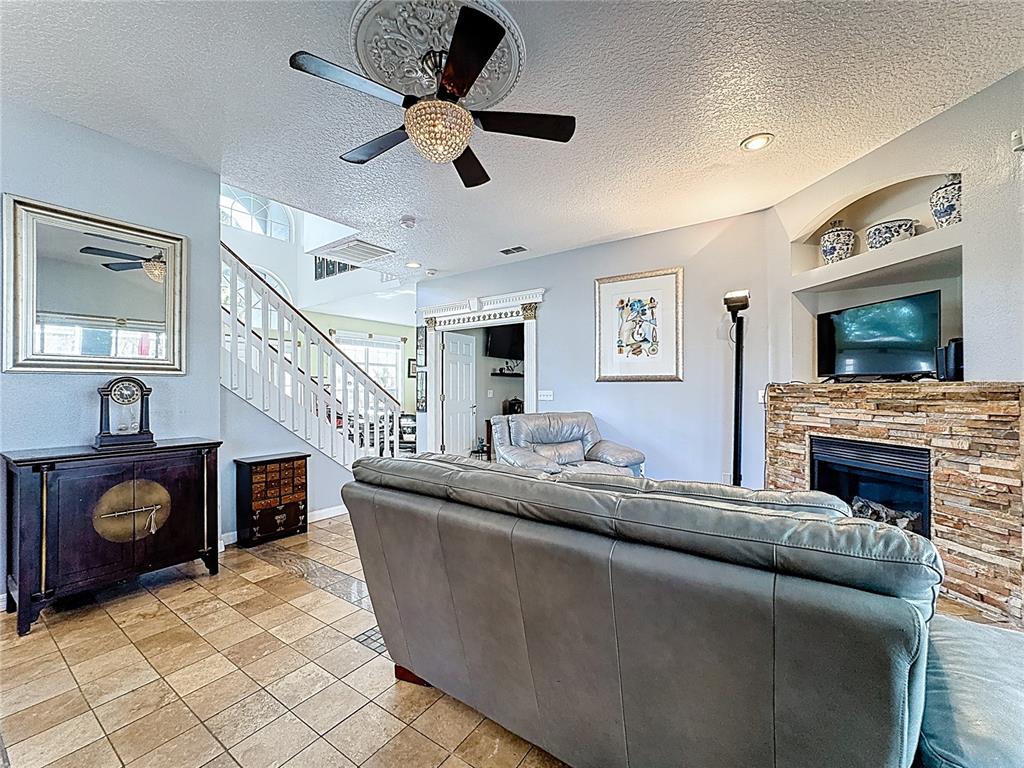 2048 Applegate Drive Ocoee, FL 34761 - Photo 43 of 61 a living room with furniture and a fireplace