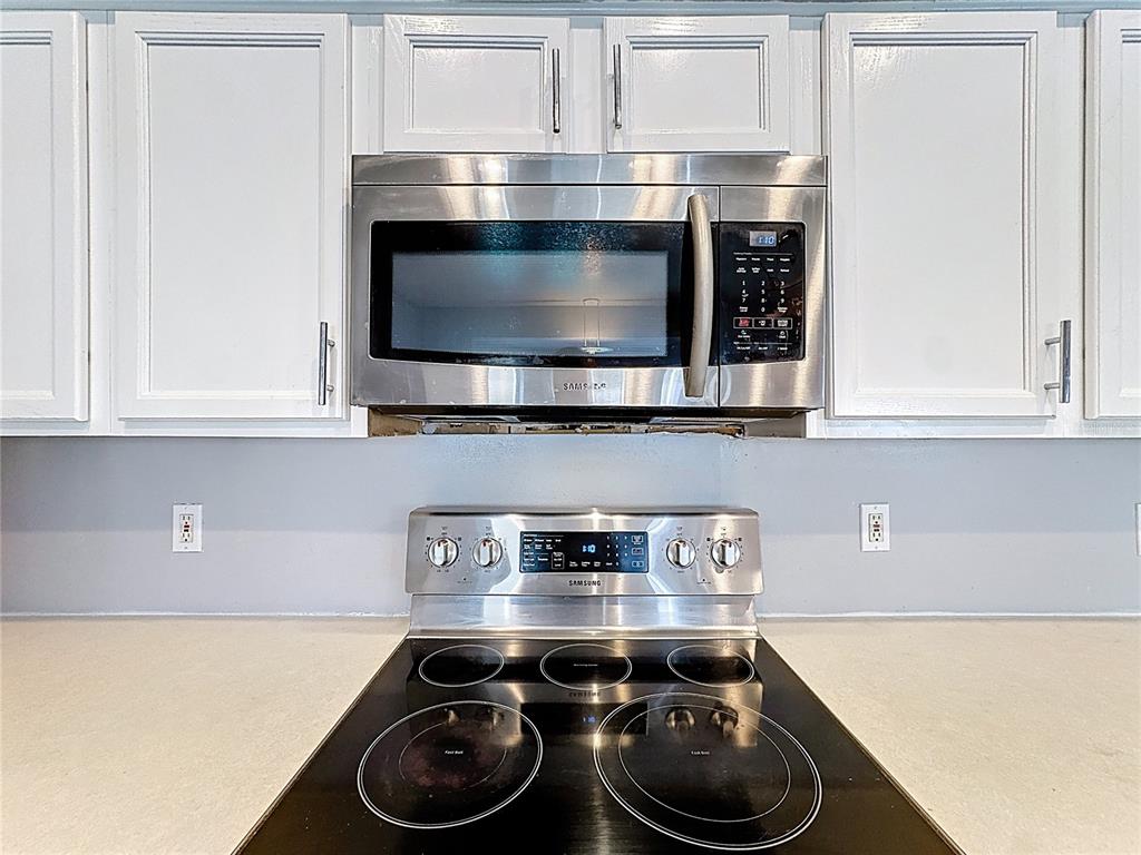 2048 Applegate Drive Ocoee, FL 34761 - Photo 48 of 61 a kitchen with a stove and cabinets