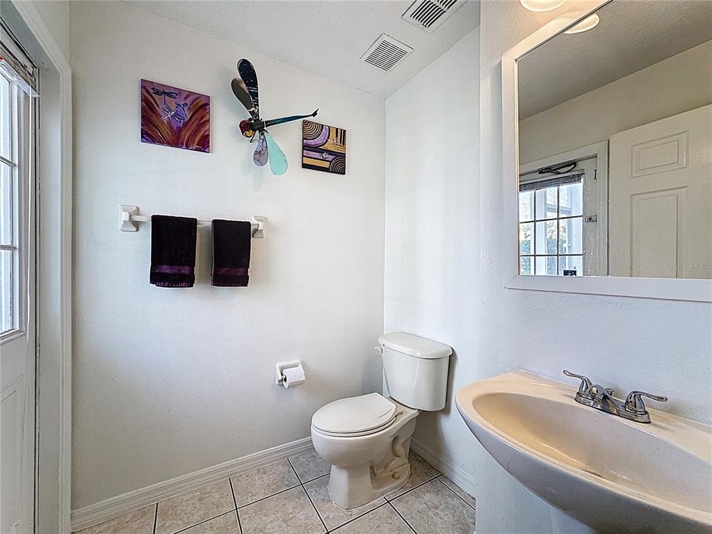 2048 Applegate Drive Ocoee, FL 34761 - Photo 59 of 61 a bathroom with a toilet a sink and mirror