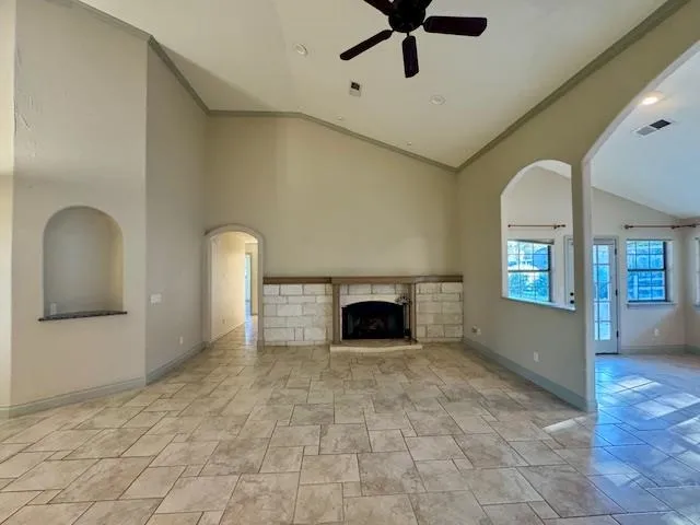 a view of a livingroom with a fireplace and window