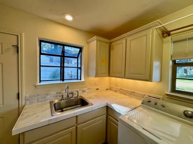 a bathroom with a sink and a window