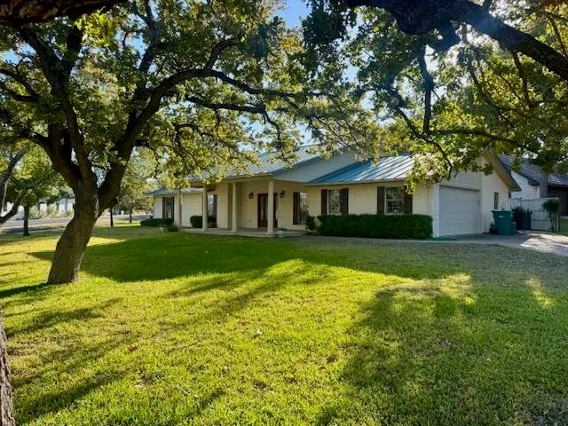 a view of house that has a yard