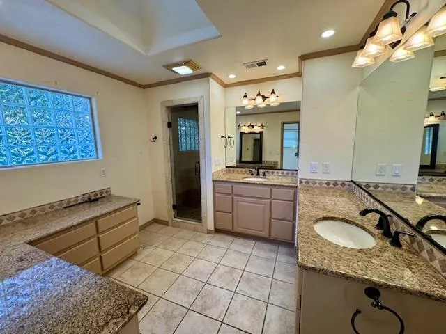 a bathroom with a granite countertop sink mirror and vanity