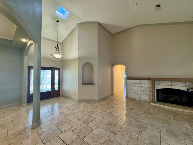 a view of empty room with a fireplace and windows