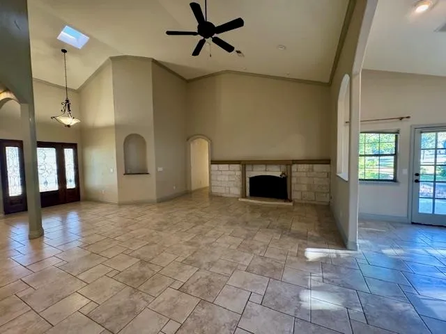a view of empty room with window and fireplace