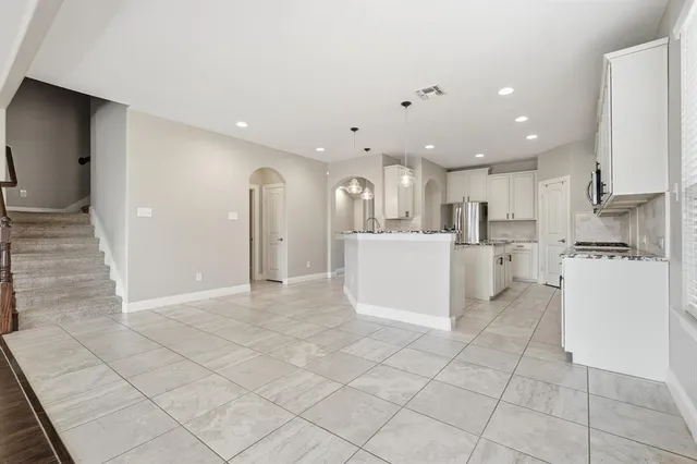 a view of empty room with wooden floor and fireplace