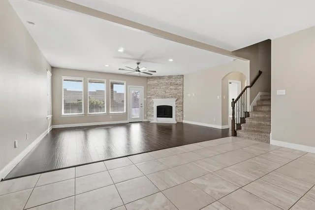 a view of a livingroom with wooden floor and a ceiling fan