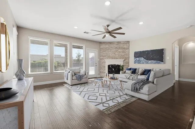 a view of a livingroom with a ceiling fan and window