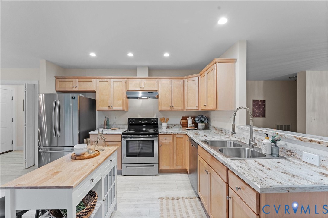 5239 Old Buckingham Road Powhatan, VA 23139 - Photo 14 of 50 a kitchen with stainless steel appliances granite countertop a sink stove refrigerator and cabinets