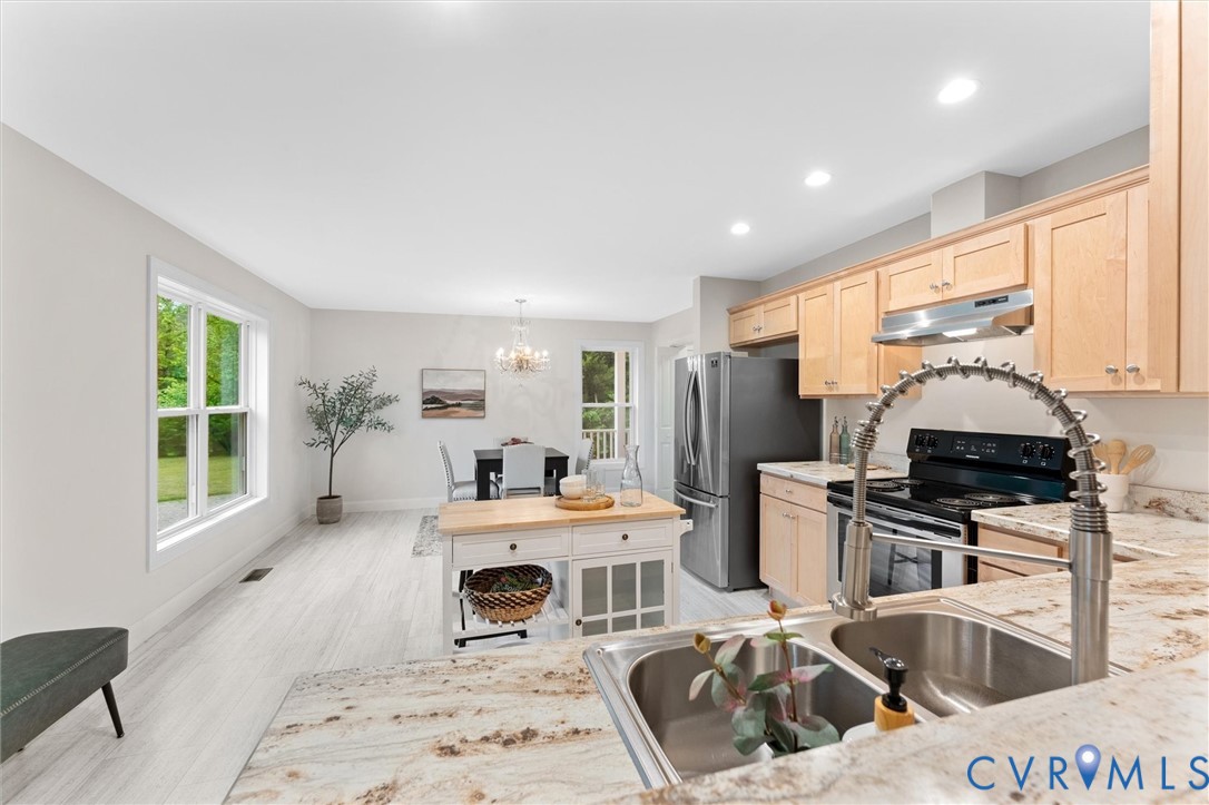5239 Old Buckingham Road Powhatan, VA 23139 - Photo 15 of 50 a kitchen with stainless steel appliances a sink a stove a refrigerator cabinets and furniture