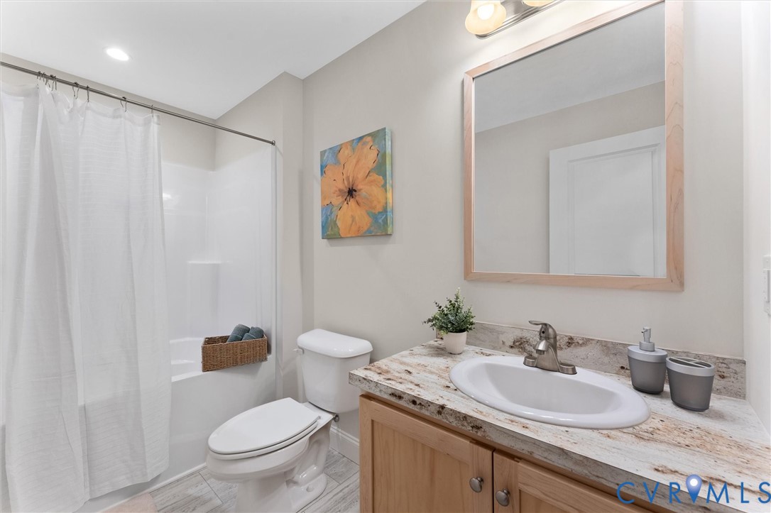5239 Old Buckingham Road Powhatan, VA 23139 - Photo 39 of 50 a bathroom with a granite countertop sink mirror vanity and toilet