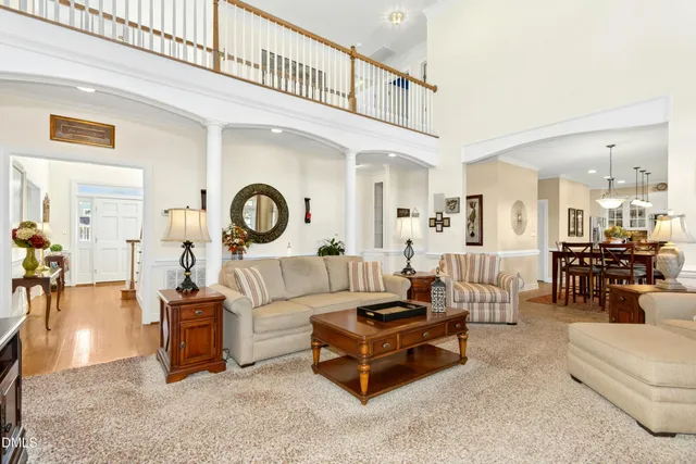 a living room with furniture a table and a chandelier