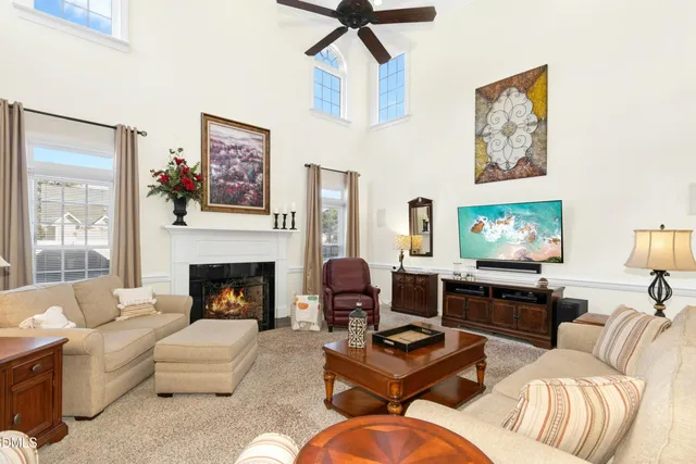 a living room with furniture fireplace and window
