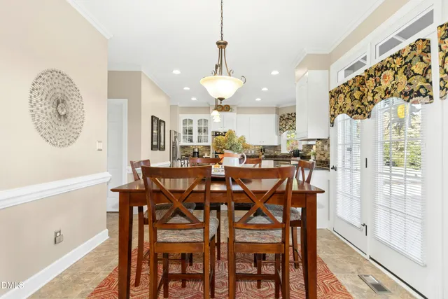a view of a dining room with furniture and a large window