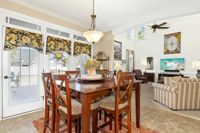 a view of a dining room with furniture and a chandelier